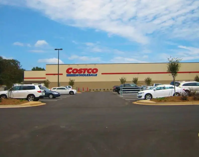 A costco store with cars parked in front of it.