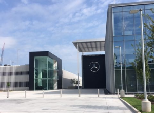 A large building with a mercedes logo on the front.