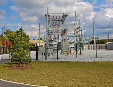 A power plant with many wires on the ground.