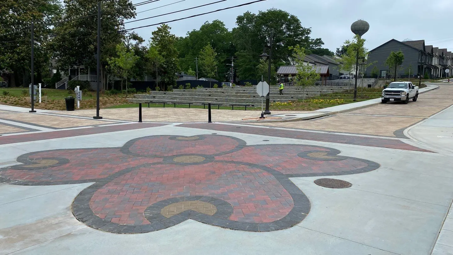 A street with a large flower painted on the ground.